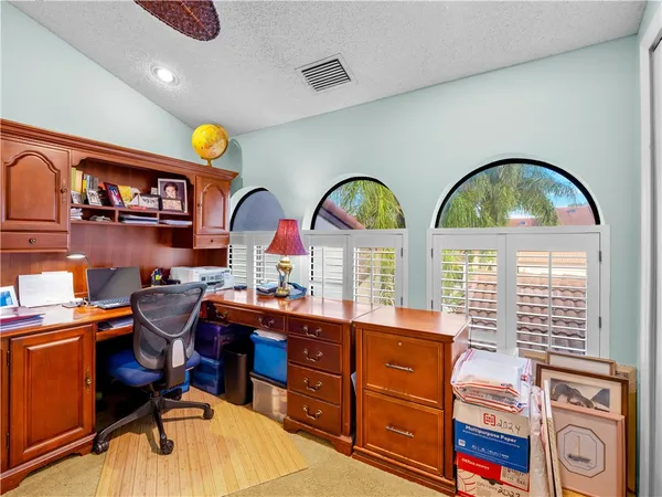 a room with two chandeliers and wooden floor