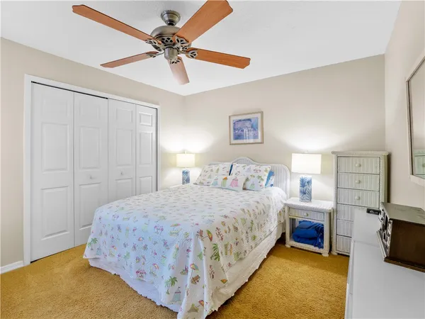 a bedroom with a bed and a ceiling fan