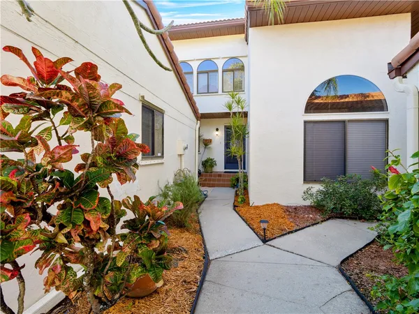 a view of a house with potted plants