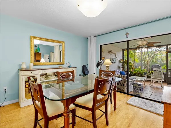a dining room with furniture and wooden floor
