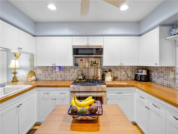 a kitchen with stainless steel appliances granite countertop a sink and cabinets