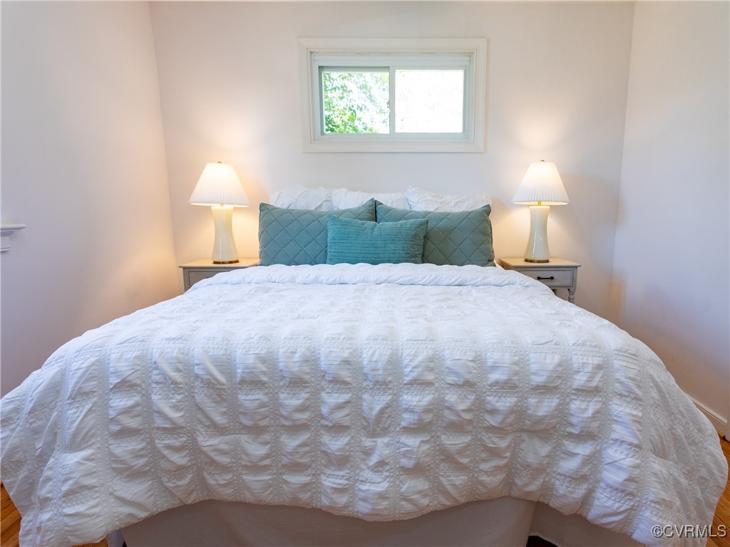 3311 Croydon Road Richmond, VA 23223 - Photo 12 of 23 a large bed sitting in a bedroom next to a lamp