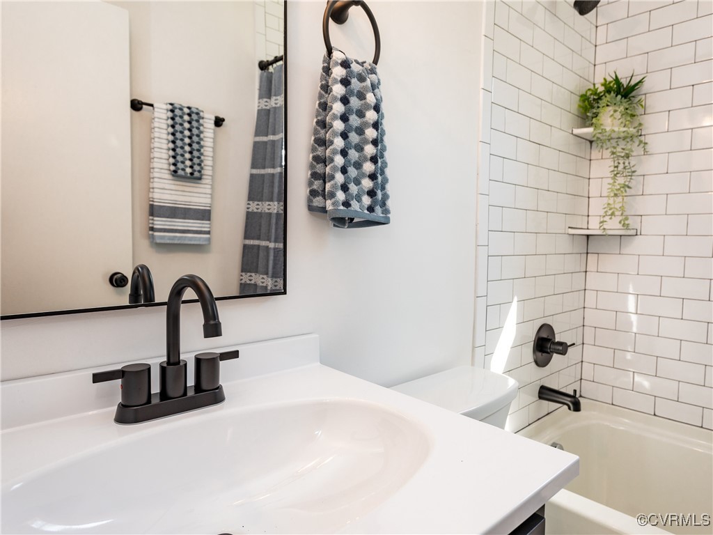 3311 Croydon Road Richmond, VA 23223 - Photo 15 of 23 a bathroom with a sink and a mirror