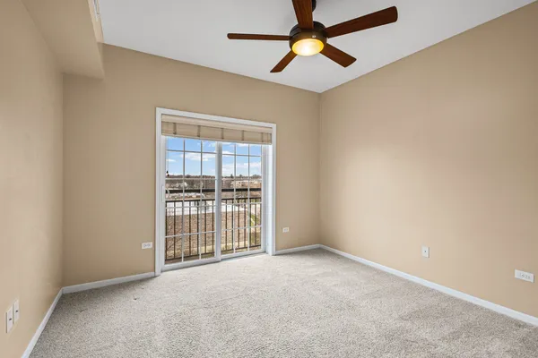 an empty room with chandelier fan