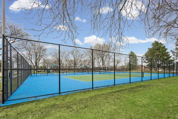 a view of yard with swimming pool and trees in the background