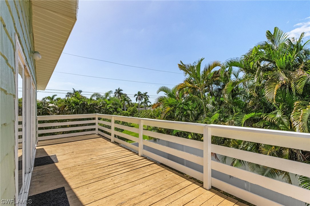 5823 Trout Road Bokeelia, FL 33922 - Photo 21 of 29 a view of a roof deck with wooden floor and fence