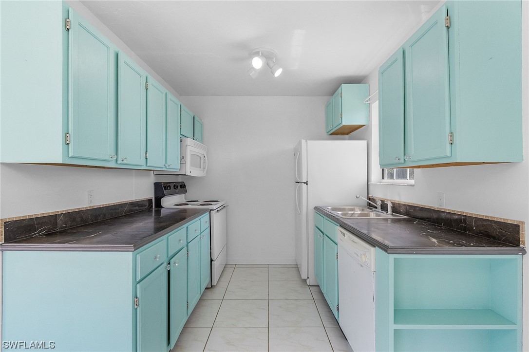 5823 Trout Road Bokeelia, FL 33922 - Photo 23 of 29 a kitchen with stainless steel appliances granite countertop a sink stove and refrigerator