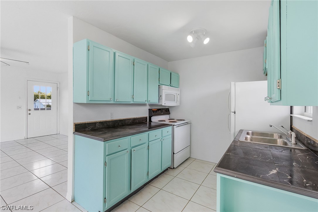 5823 Trout Road Bokeelia, FL 33922 - Photo 8 of 29 a kitchen with granite countertop a sink and a stove top oven