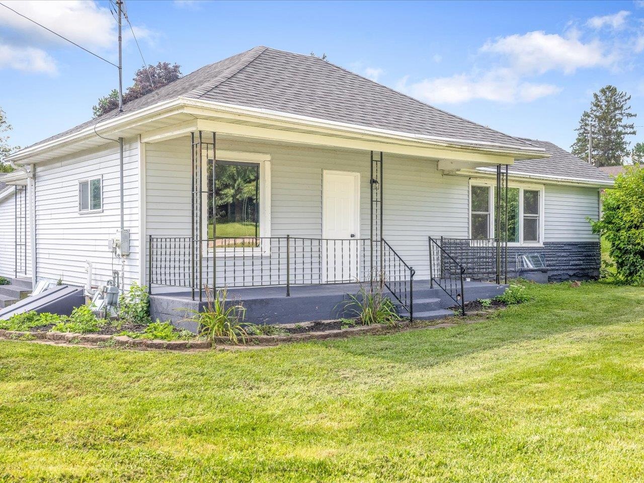 a front view of house with yard and outdoor seating
