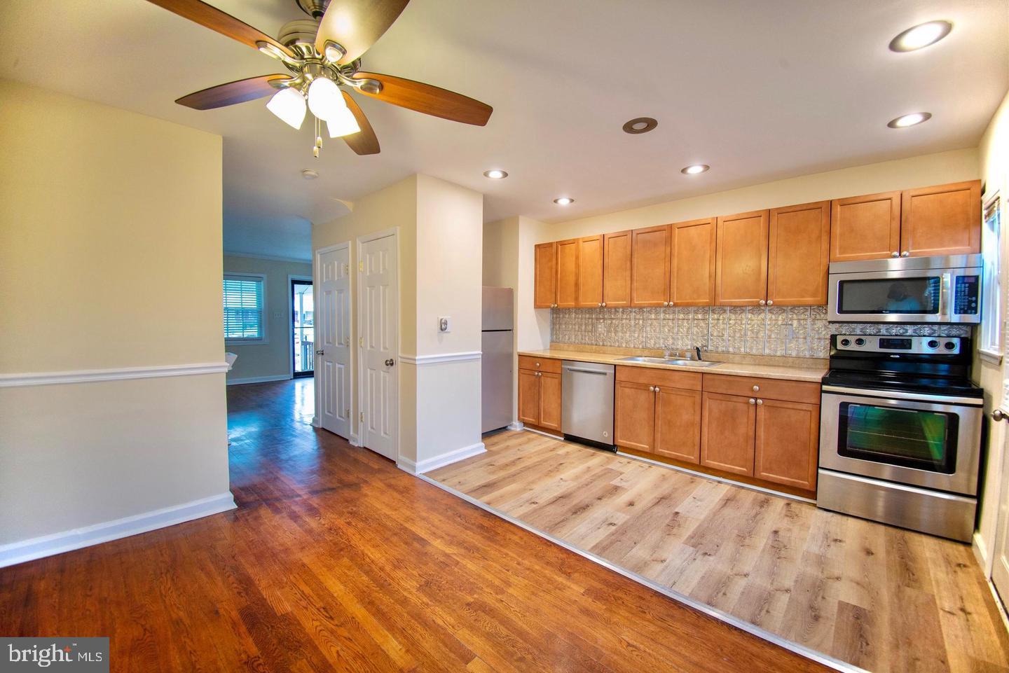 7471 Rabon Avenue Dundalk, MD 21222 - Photo 4 of 6 a kitchen with a refrigerator and a sink