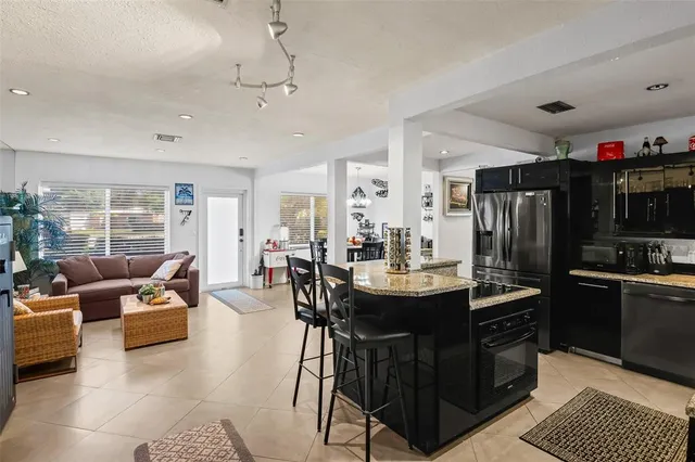 an aerial view of a house with a yard and lake view