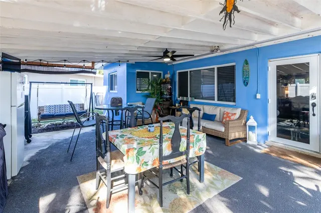 a view of a house with swimming pool and sitting area