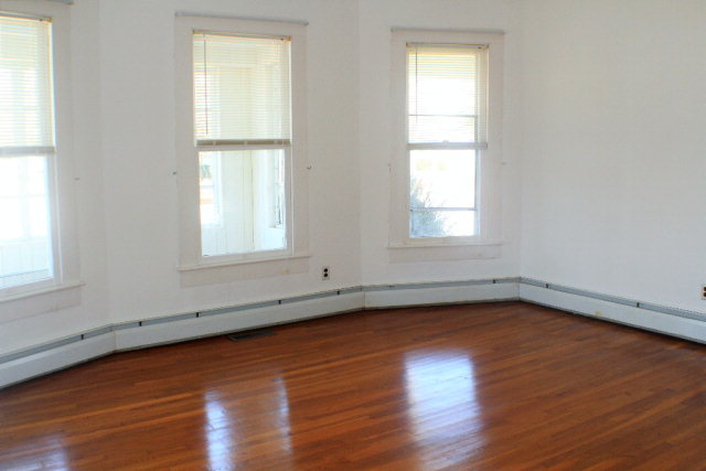 9593 Atlantic Road Atlantic, VA 23303 - Photo 8 of 20 an empty room with wooden floor and windows