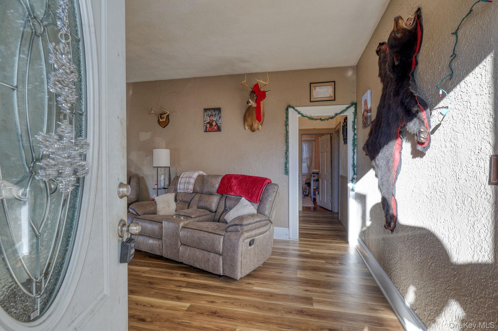 6 Willow Street Newburgh, NY 12550 - Photo 12 of 24 a living room with furniture and a wooden floor