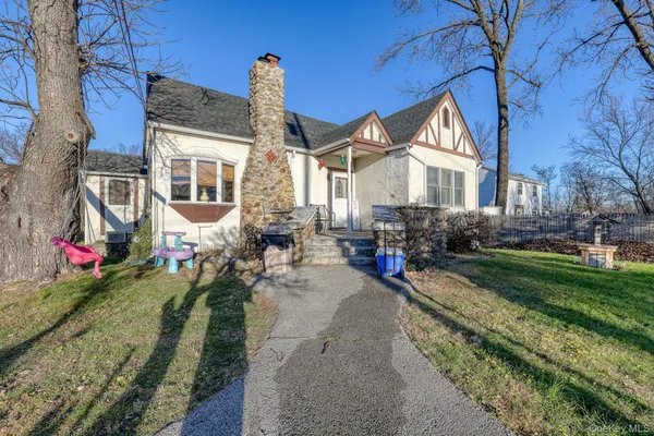a front view of a house with porch and garden