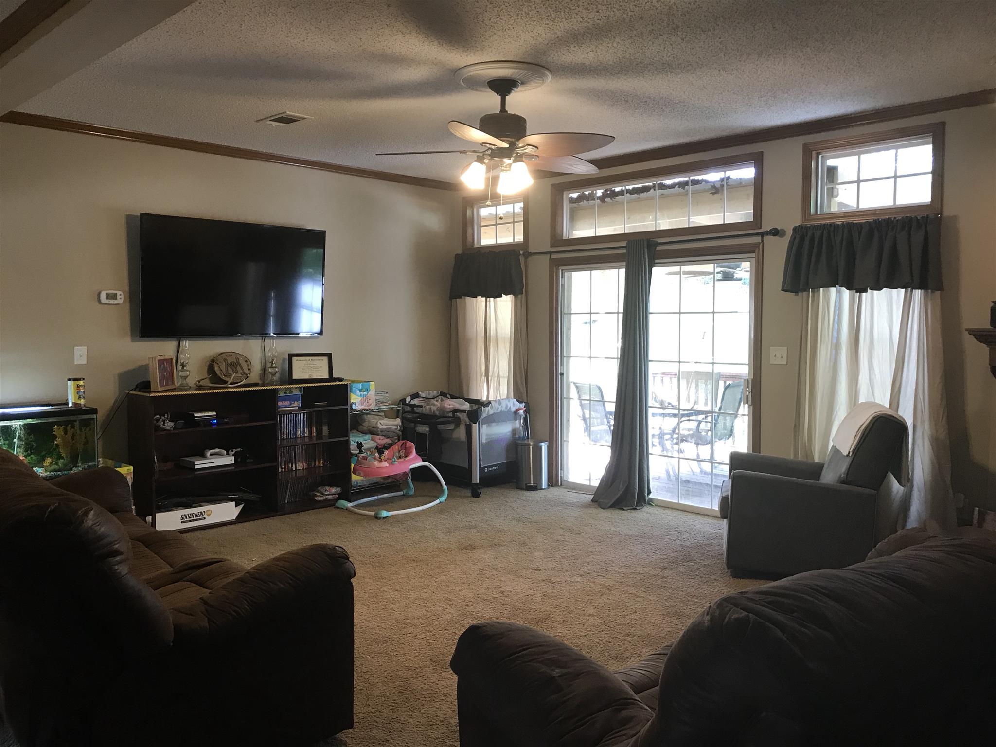 1237 Fowler Ford Road Portland, TN 37148 - Photo 3 of 17 a bedroom with furniture and a flat screen tv