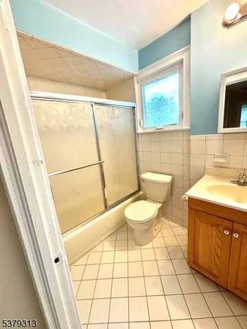 a bathroom with a sink a toilet a mirror and vanity
