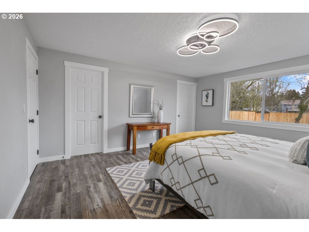 2868 Southwest 196th Avenue Beaverton, OR 97003 - Photo 15 of 34 a bedroom with a bed and a chandelier