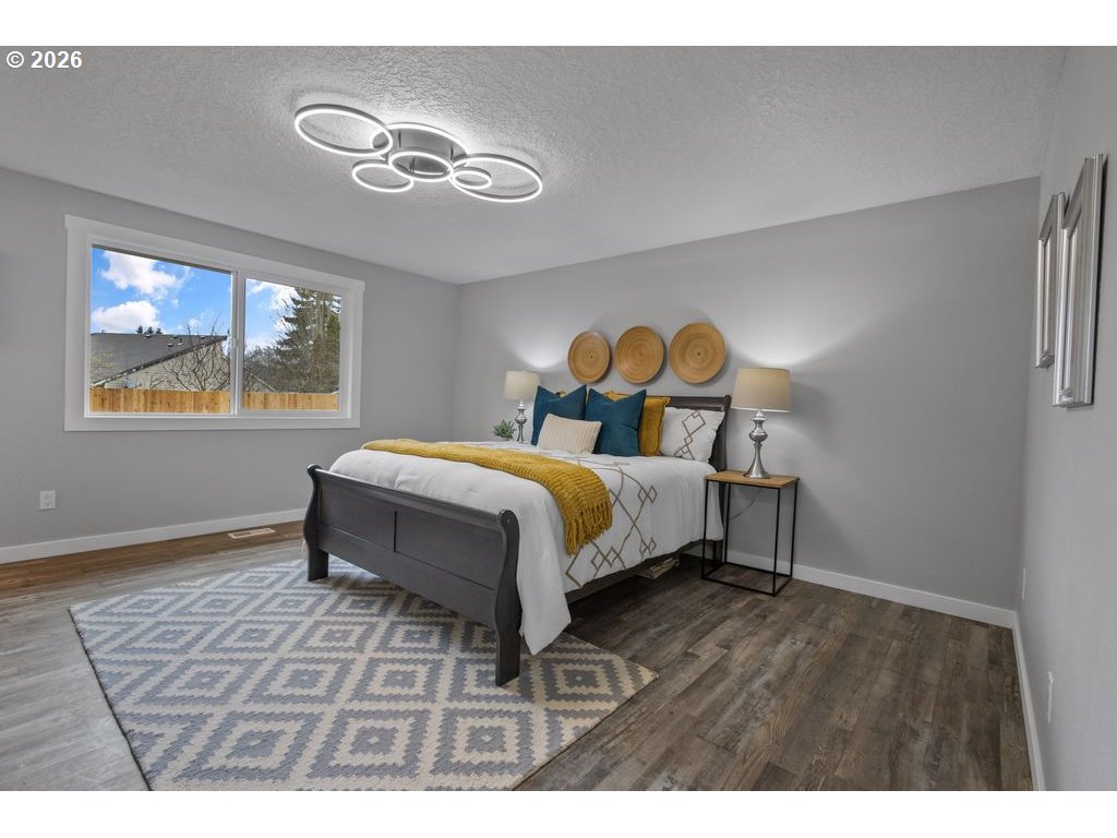 2868 Southwest 196th Avenue Beaverton, OR 97003 - Photo 17 of 34 a bedroom with a bed and a chandelier