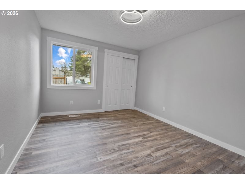 2868 Southwest 196th Avenue Beaverton, OR 97003 - Photo 18 of 34 a view of an empty room with wooden floor and a window
