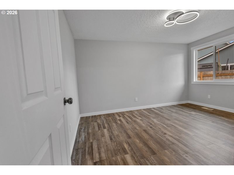 2868 Southwest 196th Avenue Beaverton, OR 97003 - Photo 19 of 34 a view of empty room with wooden floor and fan