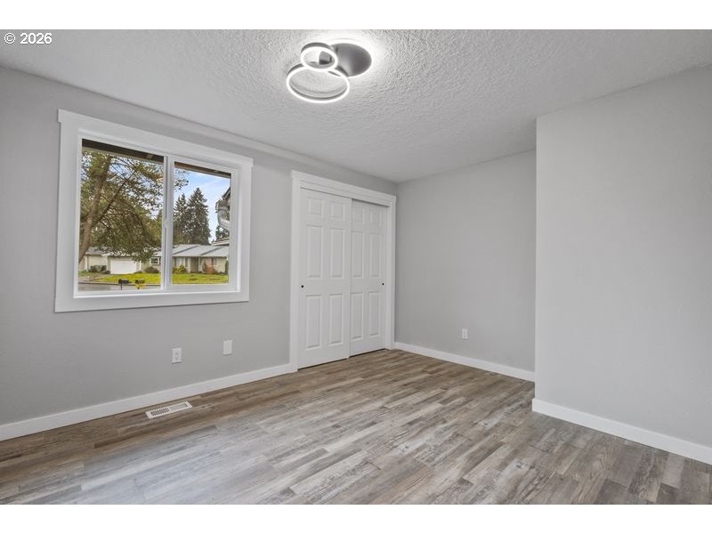 2868 Southwest 196th Avenue Beaverton, OR 97003 - Photo 24 of 34 a view of an empty room with wooden floor and a window