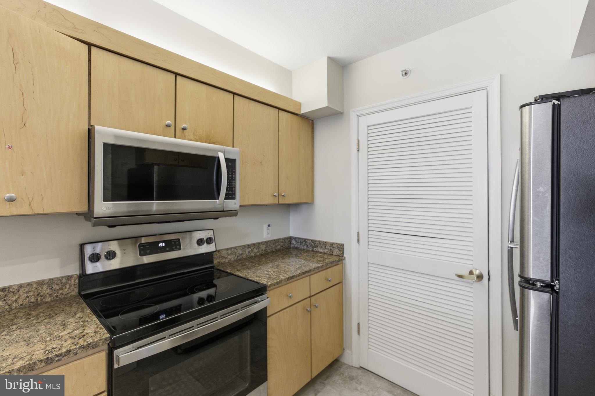 616 E Street Northwest, Unit 419 Washington, DC 20004 - Photo 11 of 30 a kitchen with a stove and a microwave