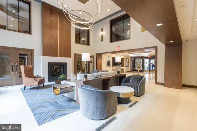 a living room with fireplace furniture and a large window