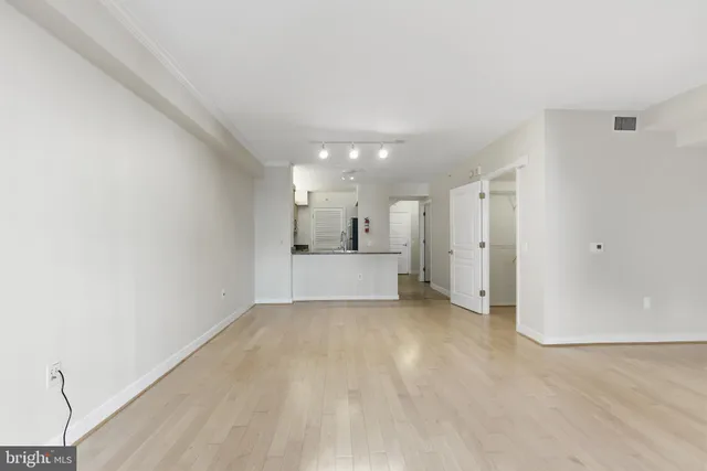a view of a kitchen with a refrigerator and a sink