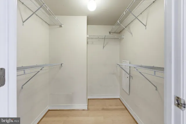 a view of walk in closet with empty racks
