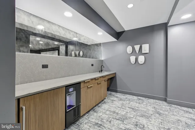 a kitchen with stainless steel appliances granite countertop lots of counter top space and wooden floor