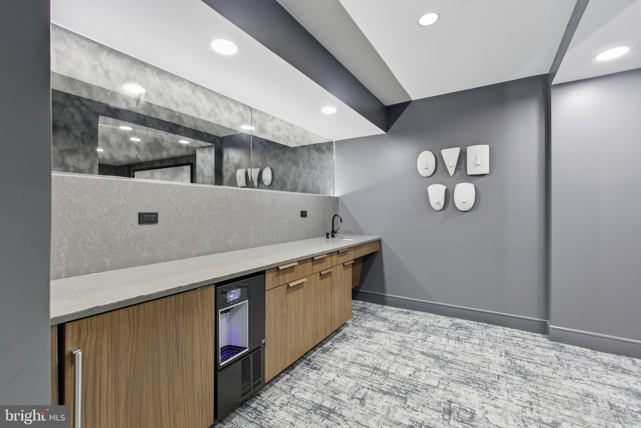 616 E Street Northwest, Unit 419 Washington, DC 20004 - Photo 7 of 30 a kitchen with stainless steel appliances granite countertop lots of counter top space and wooden floor
