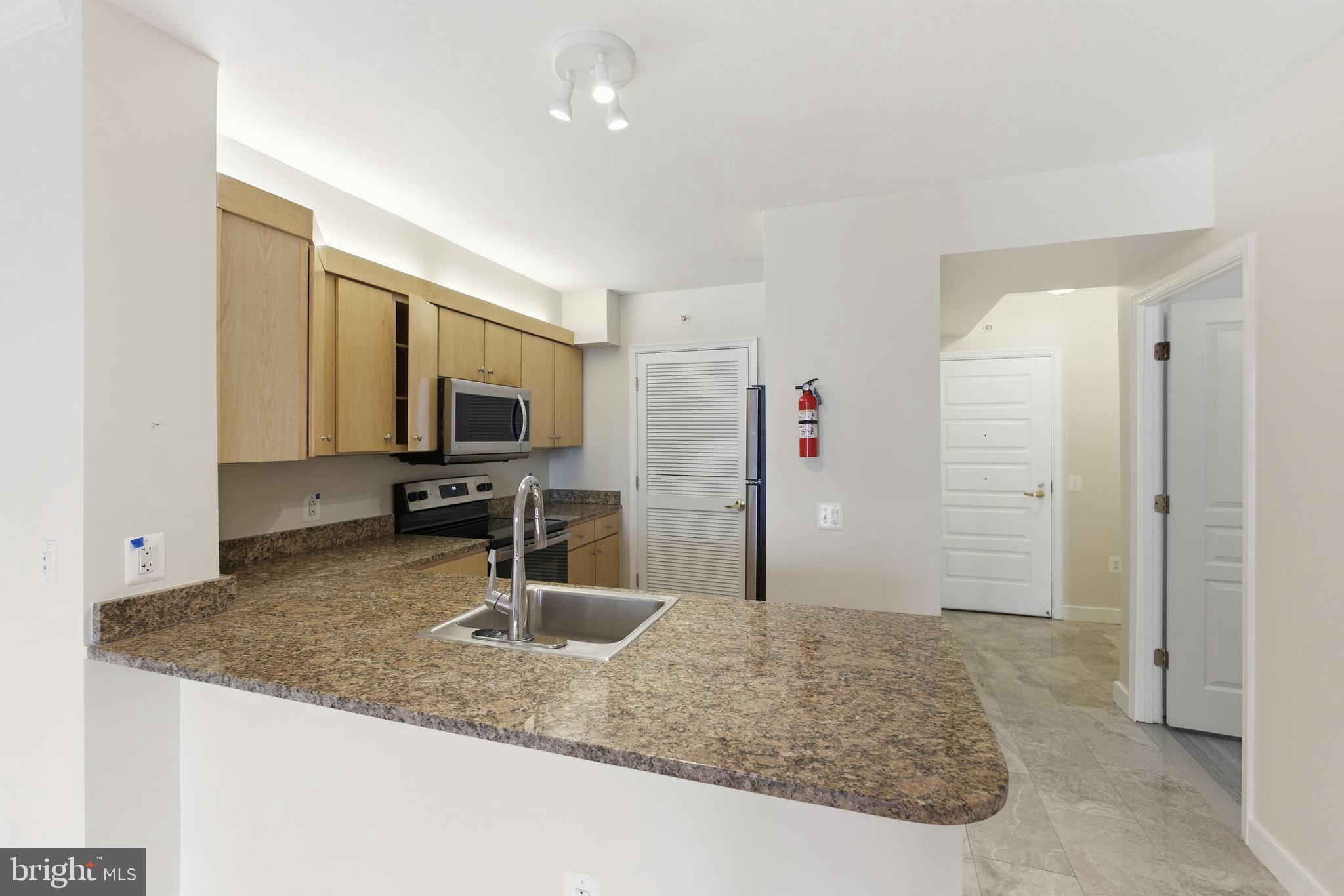 616 E Street Northwest, Unit 419 Washington, DC 20004 - Photo 10 of 30 a kitchen with sink refrigerator and faucet