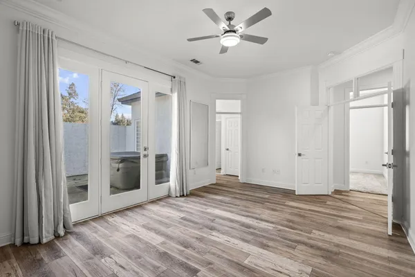 a view of a big room with wooden floor closet and windows