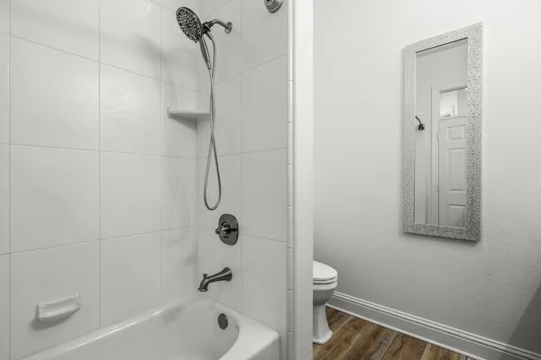 a bathroom with a shower and a toilet