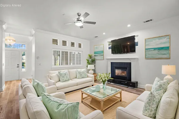 a living room with furniture a fireplace and a flat screen tv
