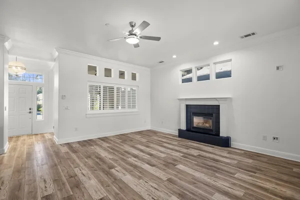 a view of empty room with windows and fireplace