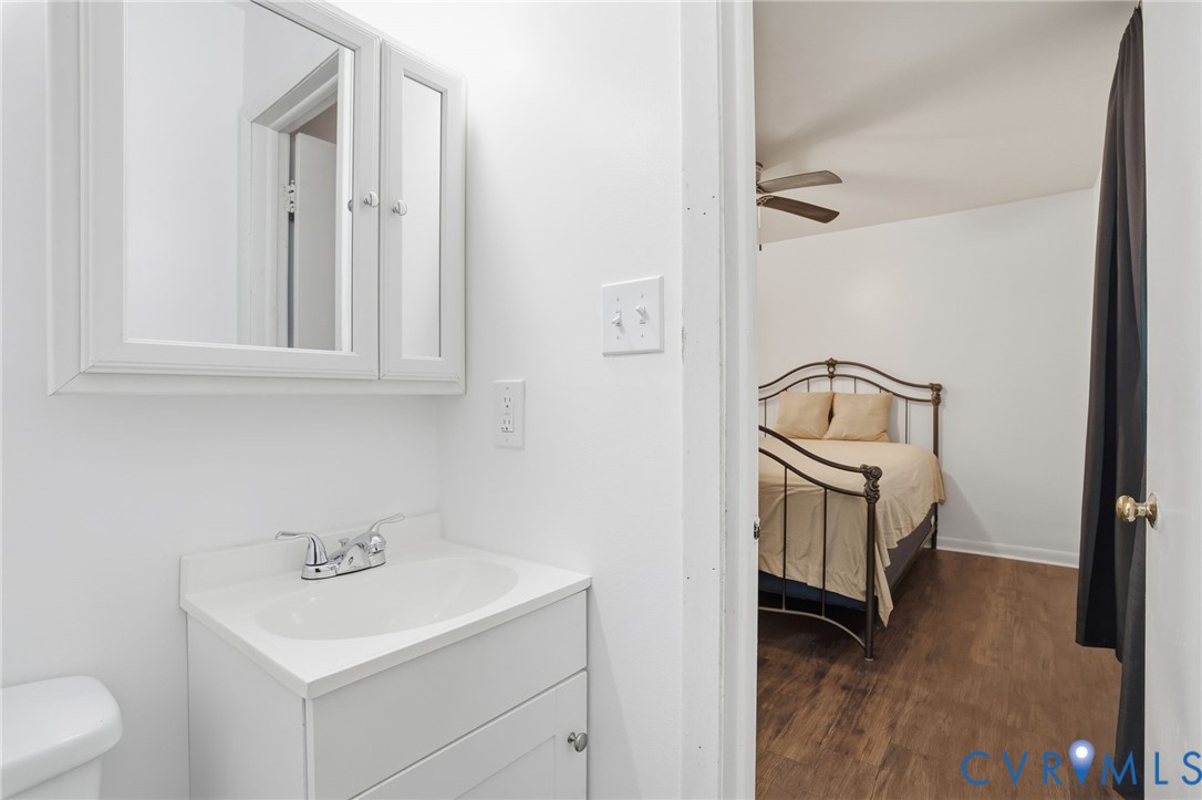 1802 Freeman Street Hopewell, VA 23860 - Photo 11 of 20 a bathroom with a toilet a sink and a mirror