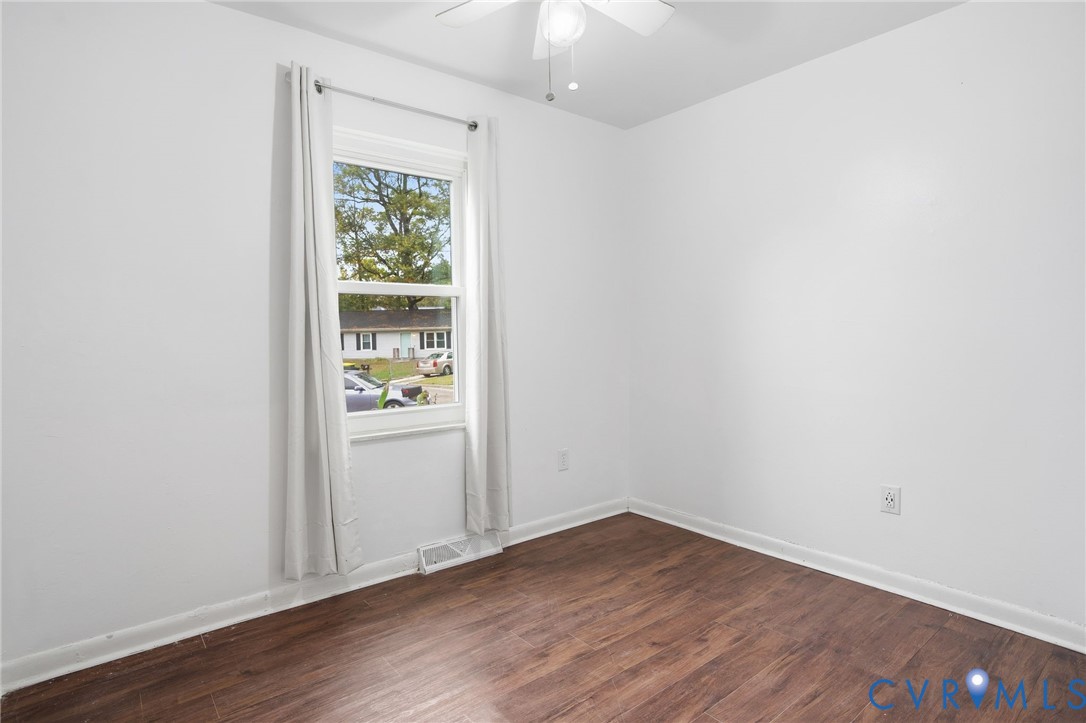 1802 Freeman Street Hopewell, VA 23860 - Photo 12 of 20 an empty room with wooden floor and window