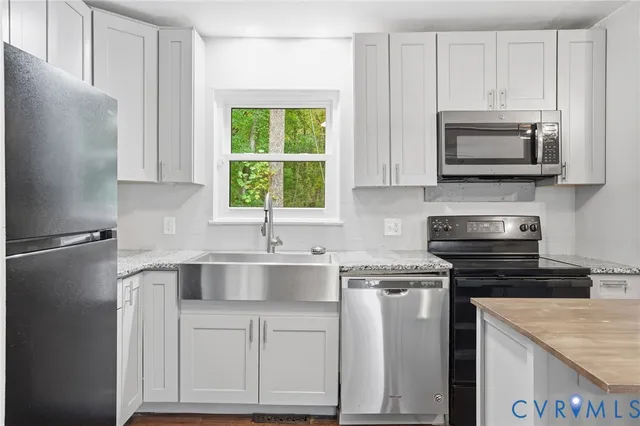 a kitchen with a sink stove and microwave