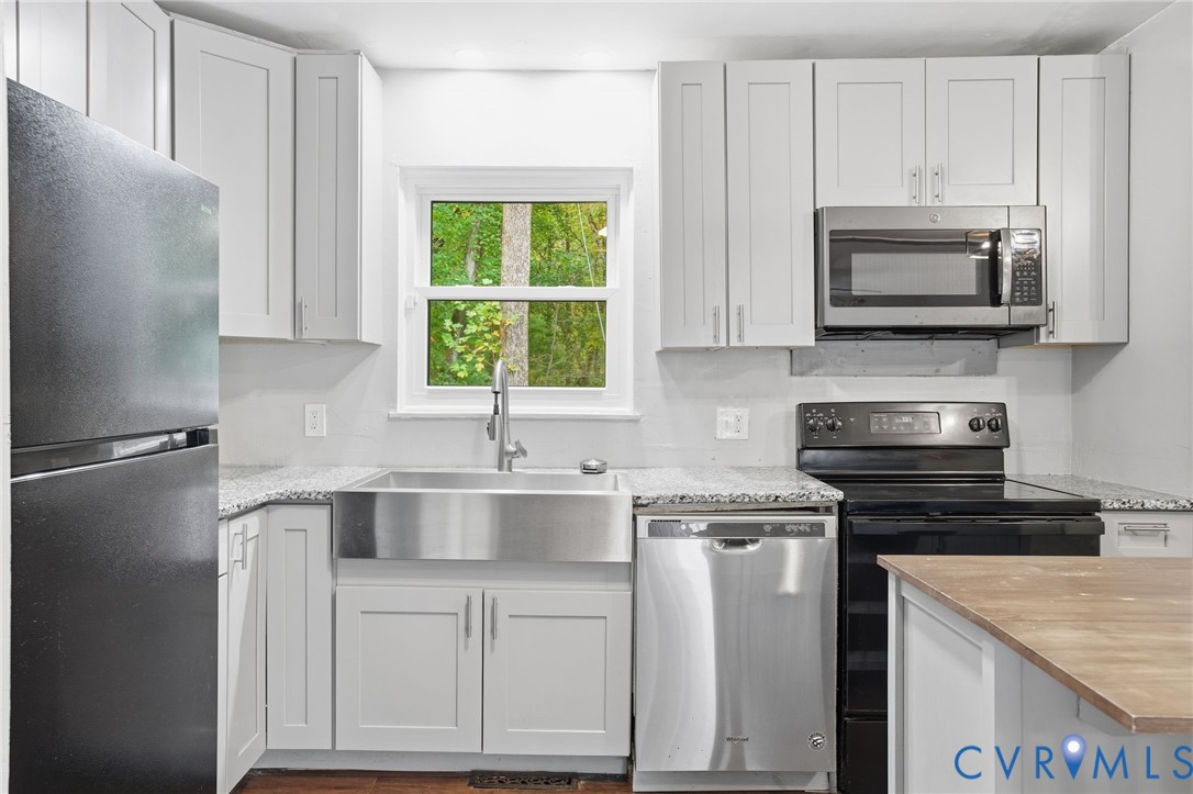 1802 Freeman Street Hopewell, VA 23860 - Photo 8 of 20 a kitchen with a sink stove and microwave
