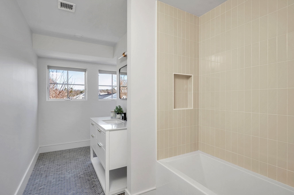 10 Chestnut Place Hingham, MA 02043 - Photo 14 of 32 a bathroom with a bathtub sink and mirror