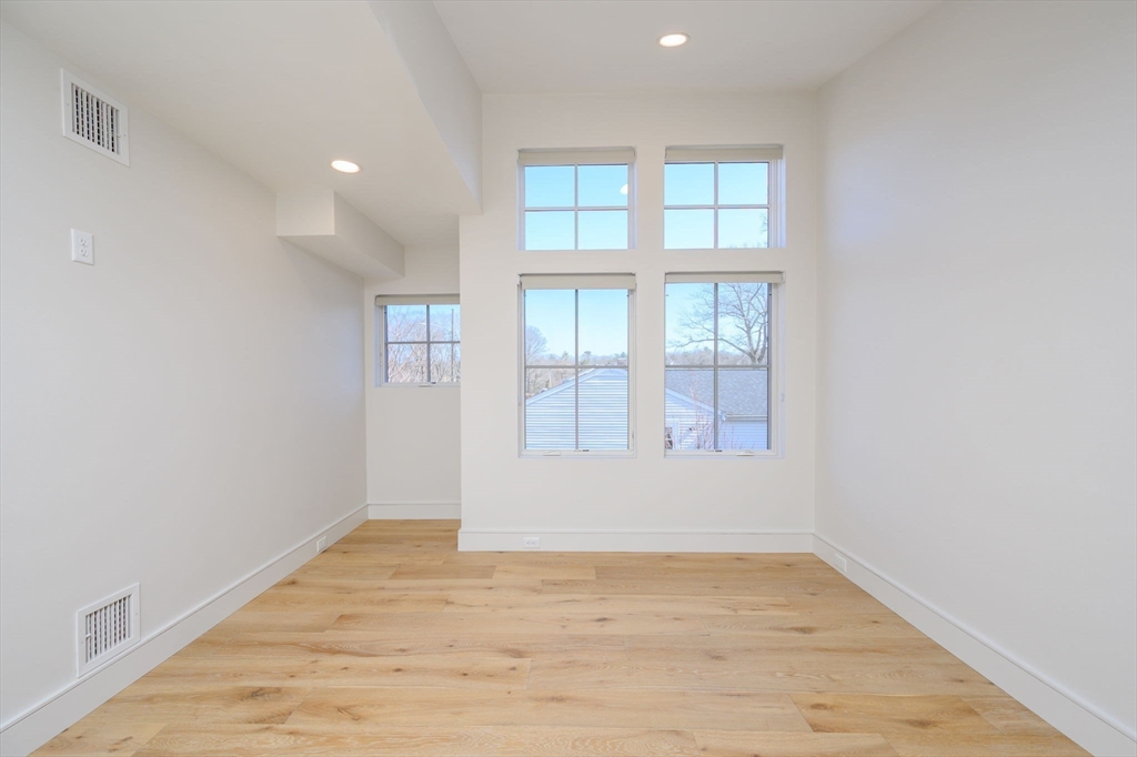 10 Chestnut Place Hingham, MA 02043 - Photo 15 of 32 an empty room with wooden floor and windows