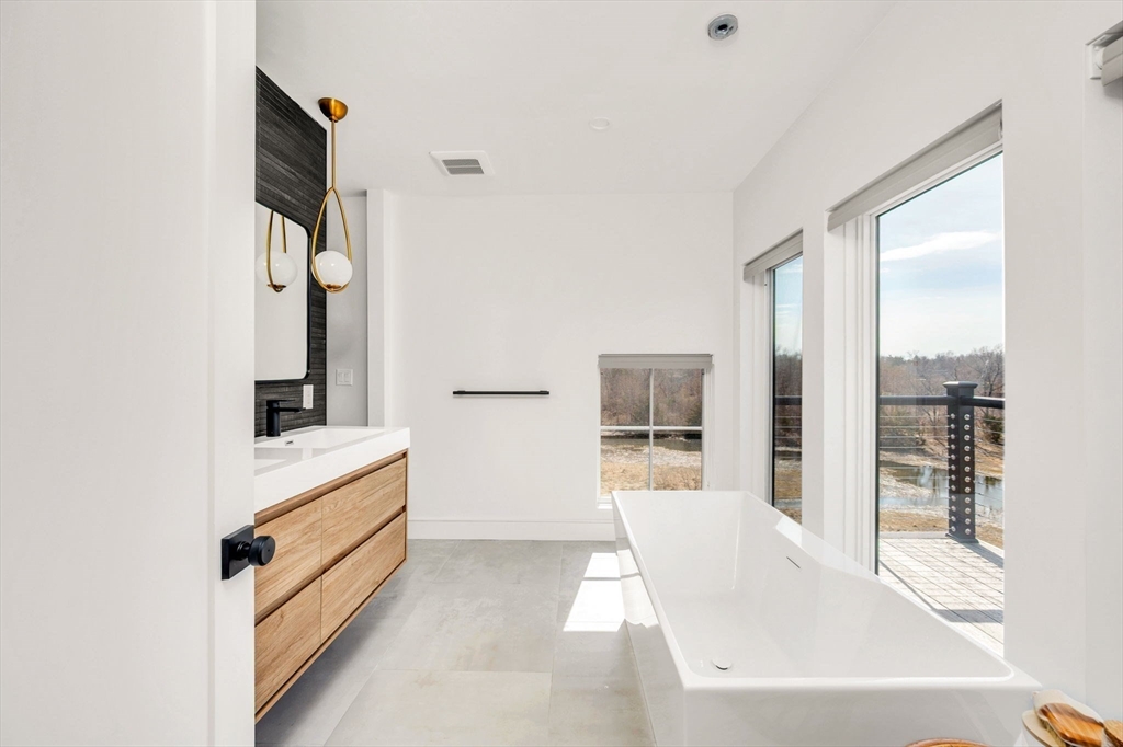10 Chestnut Place Hingham, MA 02043 - Photo 19 of 32 a bathroom with a tub sink and mirror