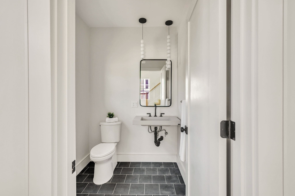 10 Chestnut Place Hingham, MA 02043 - Photo 23 of 32 a bathroom with a toilet sink and mirror