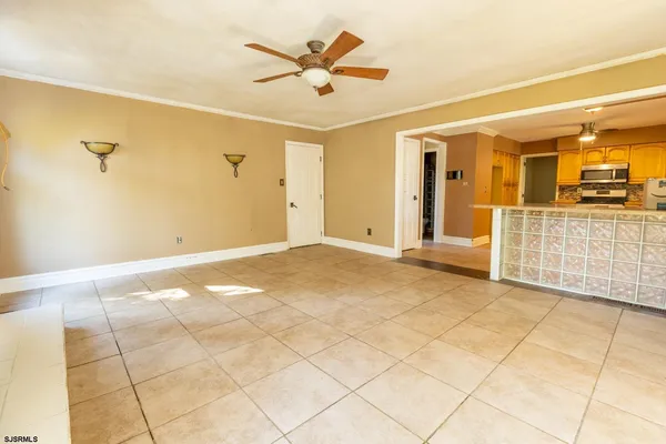 a view of a livingroom with a furniture and a ceiling fan