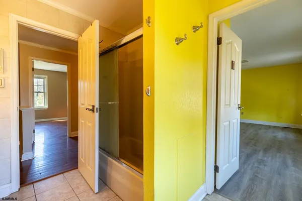 a view of a hallway with wooden floor