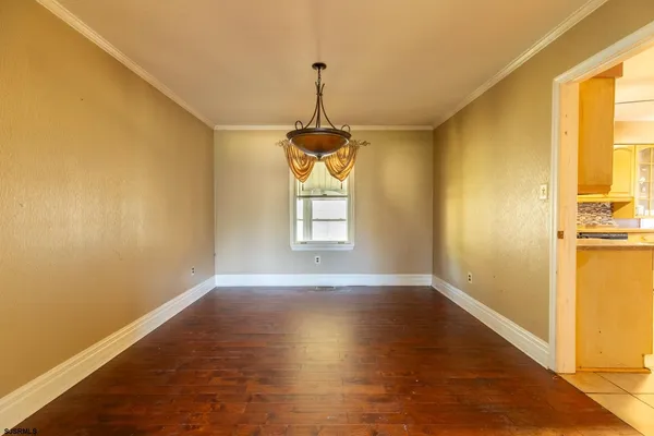 a view of a room with window and wooden floor