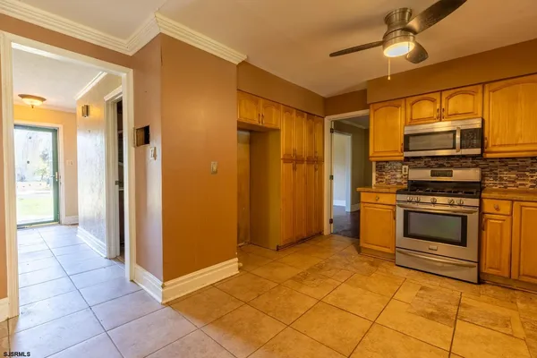 a kitchen with stainless steel appliances granite countertop a refrigerator and a stove top oven