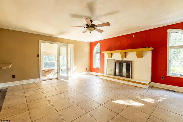 a view of a livingroom with a fireplace and a chandelier